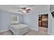 Cozy bedroom with a white bed, light blue walls, ceiling fan, and closet space at 59 Jimmy Lee Rd, Winter Haven, FL 33880