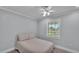 Neutral bedroom features a large window and ceiling fan, creating a relaxing and comfortable space at 59 Jimmy Lee Rd, Winter Haven, FL 33880