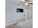 Bedroom with a tv mounted on the wall and carpet flooring at 59 Jimmy Lee Rd, Winter Haven, FL 33880