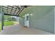 Relaxing covered patio featuring a ceiling fan and an outdoor light fixtures for evening enjoyment at 59 Jimmy Lee Rd, Winter Haven, FL 33880