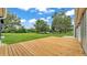 Expansive wooden deck overlooking the lush green lawn and providing ample space at 59 Jimmy Lee Rd, Winter Haven, FL 33880