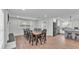 Bright dining area featuring an oversized table, seating for ten, and wood flooring at 59 Jimmy Lee Rd, Winter Haven, FL 33880