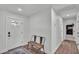 The entryway boasts wood flooring and is well-lit with a cozy bench at 59 Jimmy Lee Rd, Winter Haven, FL 33880