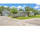 Well-maintained single-Gathering home with a lush lawn, gravel driveway, and tasteful landscaping at 59 Jimmy Lee Rd, Winter Haven, FL 33880