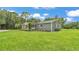 Expansive green lawn surrounds this gray home with its manicured landscaping and white trimmed windows at 59 Jimmy Lee Rd, Winter Haven, FL 33880