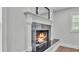 Close-up of the fireplace with black tile and white mantel in the living area at 59 Jimmy Lee Rd, Winter Haven, FL 33880