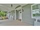 Charming front porch with classic rocking chairs and a porch swing, perfect for relaxing and enjoying the outdoors at 59 Jimmy Lee Rd, Winter Haven, FL 33880