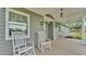 Inviting front porch with rocking chairs and a porch swing, perfect for relaxing and enjoying the outdoors at 59 Jimmy Lee Rd, Winter Haven, FL 33880