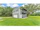 The detached garage features a second story deck with decorative pergola above the garage door at 59 Jimmy Lee Rd, Winter Haven, FL 33880