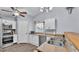 Bright kitchen with white cabinets, stainless steel appliances, and wood-look flooring at 59 Jimmy Lee Rd, Winter Haven, FL 33880