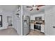 Kitchen featuring stainless steel refrigerator and appliances adjacent to dining area at 59 Jimmy Lee Rd, Winter Haven, FL 33880