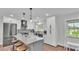 Kitchen featuring a gray island with marble countertop, stainless appliances, and white cabinets at 59 Jimmy Lee Rd, Winter Haven, FL 33880
