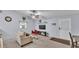 Cozy living room with plush seating, decor, and a tv with carpet flooring at 59 Jimmy Lee Rd, Winter Haven, FL 33880
