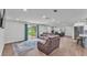 Open concept living room with fireplace and sliding glass doors to backyard at 59 Jimmy Lee Rd, Winter Haven, FL 33880