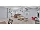Open-concept living room featuring a kitchen bar, neutral-toned furniture, and stylish décor at 59 Jimmy Lee Rd, Winter Haven, FL 33880