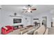 Cozy living room features a ceiling fan, comfortable seating, and a convenient workspace at 59 Jimmy Lee Rd, Winter Haven, FL 33880