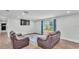Open concept living area with wood floors, sofas, and view to backyard at 59 Jimmy Lee Rd, Winter Haven, FL 33880