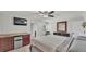 This main bedroom features a wet bar, a mounted television, and a ceiling fan at 59 Jimmy Lee Rd, Winter Haven, FL 33880