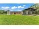 Inviting rear exterior showcasing a spacious yard and cozy covered patio of the house at 59 Jimmy Lee Rd, Winter Haven, FL 33880