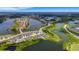 Scenic aerial view of a lakeside community with modern homes nestled along winding roads and green spaces at 6261 Great Bear Dr, Lakeland, FL 33805