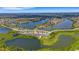Expansive aerial view of a lakeside community with well-maintained homes and lush landscaping at 6261 Great Bear Dr, Lakeland, FL 33805
