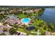 Aerial view of community pool, clubhouse, and playground with lush landscaping on a sunny day at 6261 Great Bear Dr, Lakeland, FL 33805