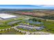 Overhead view of residential homes near commercial development and natural ponds, offering a balanced environment at 6261 Great Bear Dr, Lakeland, FL 33805
