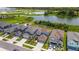Aerial view of several modern two-story homes with well-maintained landscaping and a tranquil lake backdrop at 6261 Great Bear Dr, Lakeland, FL 33805
