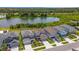 Aerial view of modern homes with neat landscaping, driveways, and a scenic view of the lake at 6261 Great Bear Dr, Lakeland, FL 33805