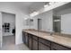 Bathroom with a double granite vanity, large mirror, and walk in shower at 6261 Great Bear Dr, Lakeland, FL 33805
