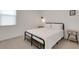 Bright bedroom features a black metal bed frame and two wood nightstands at 6261 Great Bear Dr, Lakeland, FL 33805