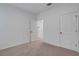 Neutral bedroom featuring carpeted floors and white walls with access to closet at 6261 Great Bear Dr, Lakeland, FL 33805
