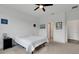Bedroom with carpet, a ceiling fan, and a double door closet, offering comfort and functionality at 6261 Great Bear Dr, Lakeland, FL 33805