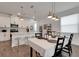 Dining area adjacent to a modern kitchen with an eat-in breakfast bar at 6261 Great Bear Dr, Lakeland, FL 33805