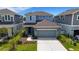 Inviting two-story home with a gray garage, and a manicured lawn at 6261 Great Bear Dr, Lakeland, FL 33805