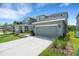 Lovely single Gathering home showcasing an attached garage and driveway framed by lush landscaping at 6261 Great Bear Dr, Lakeland, FL 33805