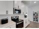 Kitchen featuring stainless steel appliances, quartz countertops, and sleek white cabinetry at 6261 Great Bear Dr, Lakeland, FL 33805