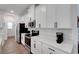 The bright kitchen is equipped with stainless steel appliances, white cabinetry, and quartz countertops at 6261 Great Bear Dr, Lakeland, FL 33805