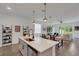 Open kitchen with quartz countertop island, stainless steel appliances, and adjacent dining and living area at 6261 Great Bear Dr, Lakeland, FL 33805