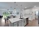 Open-concept kitchen with a large island, stainless steel appliances, and an adjacent dining area at 6261 Great Bear Dr, Lakeland, FL 33805