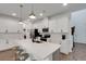 Bright white kitchen boasts a central island, stainless steel appliances, and modern finishes at 6261 Great Bear Dr, Lakeland, FL 33805