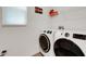Laundry room with front load washer and dryer plus wire shelving at 6261 Great Bear Dr, Lakeland, FL 33805
