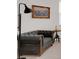 Living room area with grey loveseat, floor lamp, and framed artwork on the wall at 6261 Great Bear Dr, Lakeland, FL 33805
