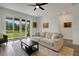 Bright living room featuring a sliding glass door and neutral decor at 6261 Great Bear Dr, Lakeland, FL 33805
