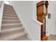 Carpeted staircase next to entryway and antique grandfather clock at 6261 Great Bear Dr, Lakeland, FL 33805