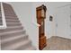 Carpeted staircase next to entryway and antique grandfather clock at 6261 Great Bear Dr, Lakeland, FL 33805