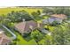Aerial view of home with a large, green yard, mature trees, and a sprawling community nearby at 633 Hart Lake Dr, Winter Haven, FL 33884