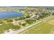 Aerial view featuring homes with lush landscaping near a beautiful lake in a residential neighborhood at 633 Hart Lake Dr, Winter Haven, FL 33884