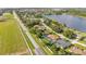 Aerial view of homes and community, near the lake, with mature trees and manicured lawns at 633 Hart Lake Dr, Winter Haven, FL 33884