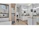 Bright bathroom with a walk-in shower, double vanity, and wood look floors at 633 Hart Lake Dr, Winter Haven, FL 33884
